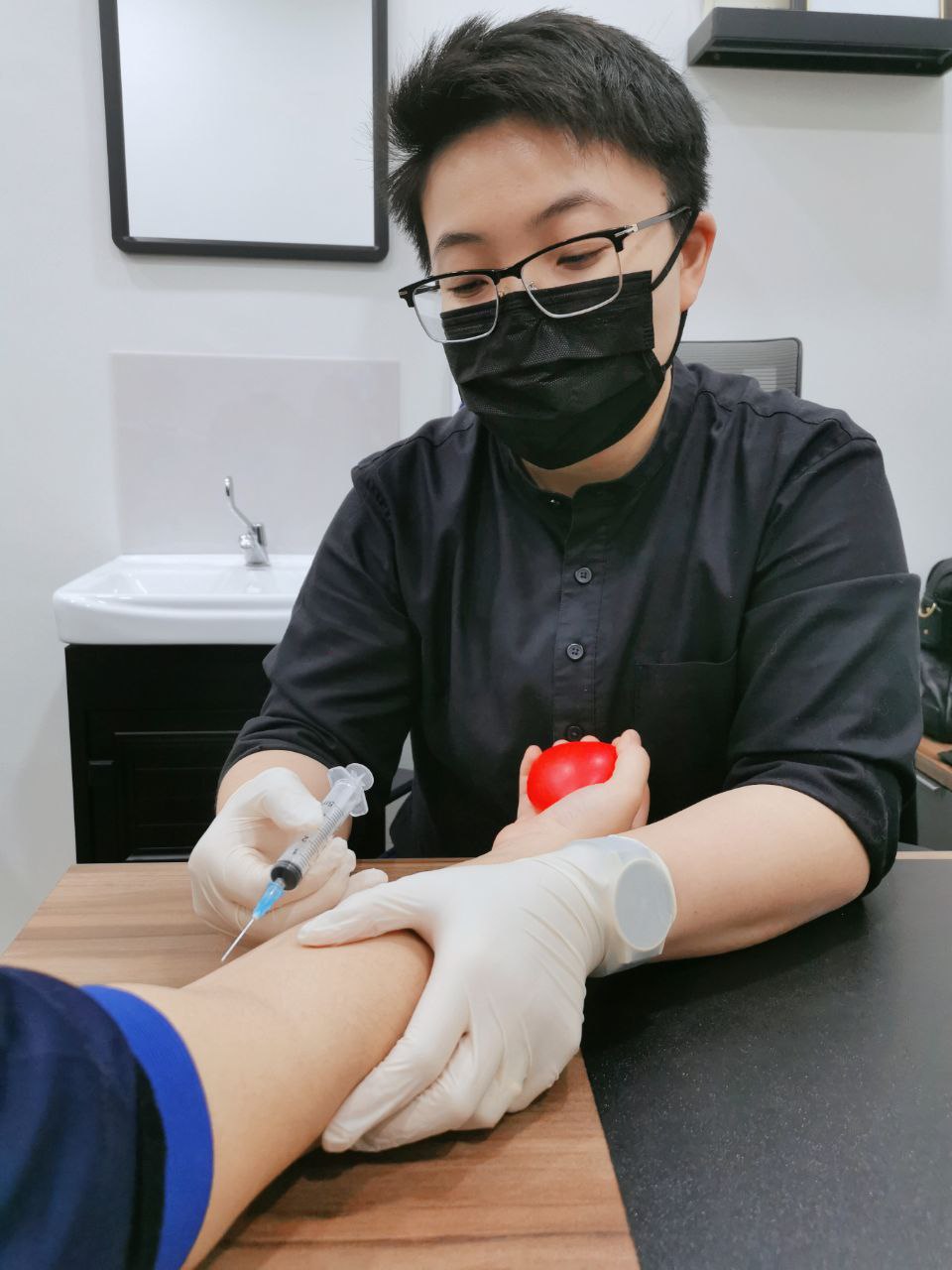 Blood sample collection during a medical check-up at the clinic
