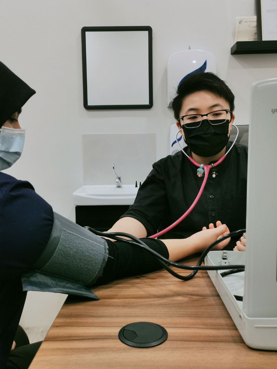 Doctor taking a patient&rsquo;s blood pressure during a general consultation